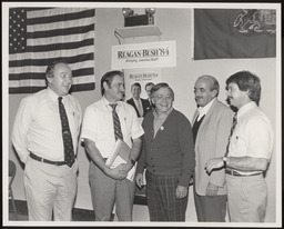At White Deer Park, these men stand in front of a poster for Presidency candidate Reagan-Bush '84.