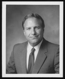 1989, Black and white official portrait with spotted tie.