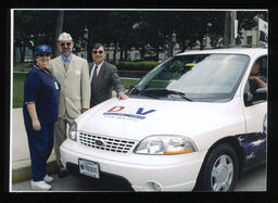  Rep. Paul W. Semmel next to a van in the Disabled American Veterans (DAV) Van Driveaways Program