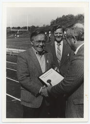 Rep. Brandt presenting a recognition award on the football field to Dr. Robert N. Aebersold, President of Slippery Rock University