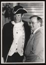Rep. Brandt standing in the capitol rotunda with a costumed man.