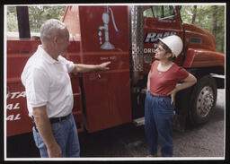 Rep. Mary Ann Dailey with a well driller, Dick Raab, next to the well drilling truck.