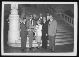 Rep. Edward Burns with a group of people holding a citation from the House of Representatives.