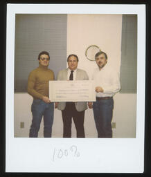 Polaroid photo, Rep. Tangretti presents a check to Greensburg Township supervisors.