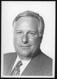 2001, Black and white official portrait with paisley tie.