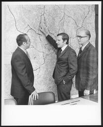 James Kelly pointing at a large map front