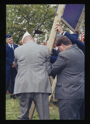 Rep. Paul Semmel helping to put the construction sign for the PA Veterans Memorial at Ft. Indiantown Gap National Cemetery into the ground.